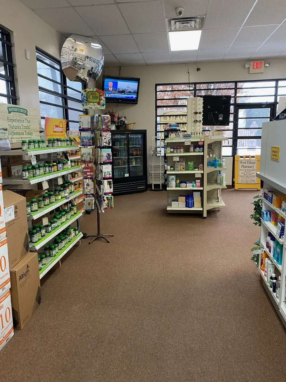 The sales floor, with a yellow sign reading Fast and Friendly Service That You Can Rely On and Free Delivery to a limited area.