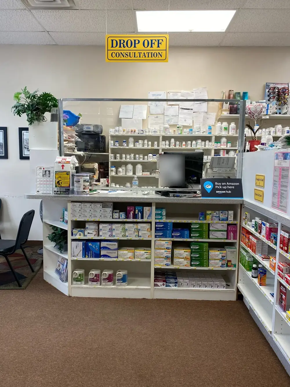 The Drop Off and Consultation counter, with prescription shelves behind a clear shield and diabetic supplies stocked below.